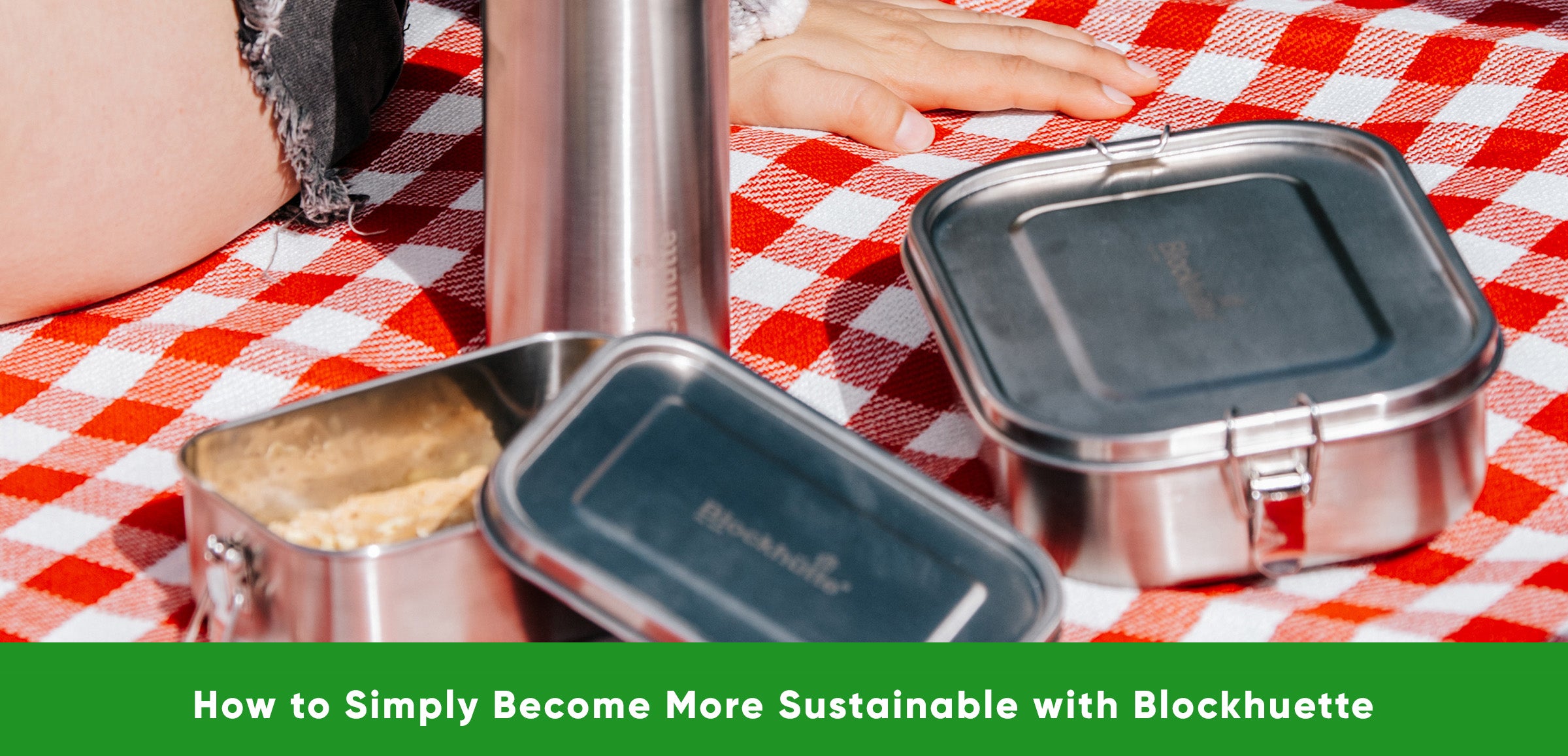 Blockhuette stainles steel lunch boxes and water bottle on a checkered blanket