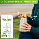 Person outdoors lifting food by spoon from an open 24 oz steel food jar; wide mouth 2.75 in, 0.89 lb, 18/8 steel, BPA free
