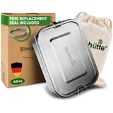 Stainless steel lunch box, closed, 40 oz, standing in front of its cardboard box and a cotton drawstring bag