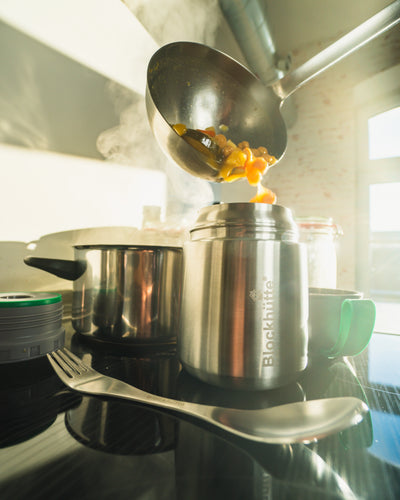 Blockhütte insulated food jar being filled with stew from a ladle