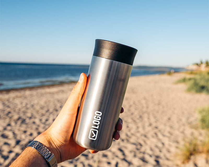 Insulated travel mug with an engraved company logo
