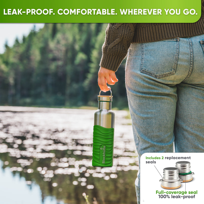 Person in jeans and a knit sweater by a lake, carrying the 25 oz bottle in a bright green silicone sleeve by the cap handle; inset: caps with replacement seals
