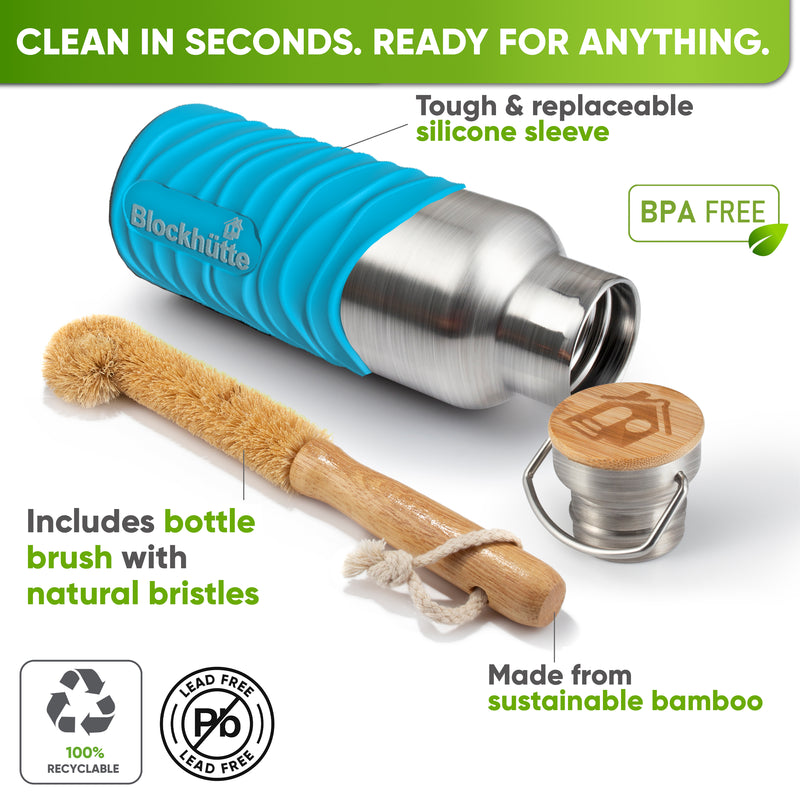 Bottle in a turquoise silicone sleeve lying on its side next to a bamboo bottle brush with natural bristles and the bamboo cap