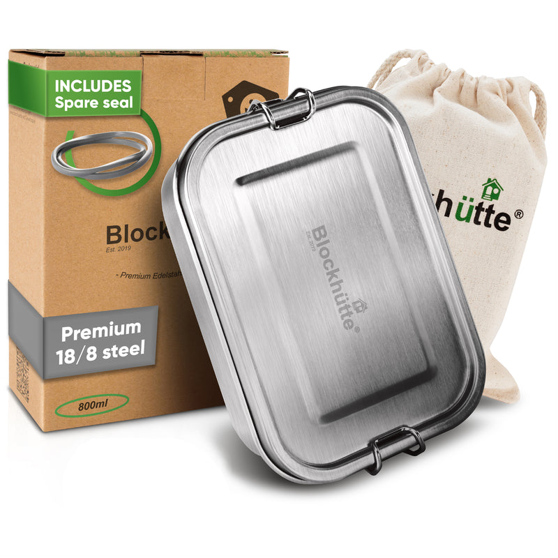 Stainless steel lunch box, 27 oz, closed, in front of its box labeled Includes spare seal and a cotton drawstring bag