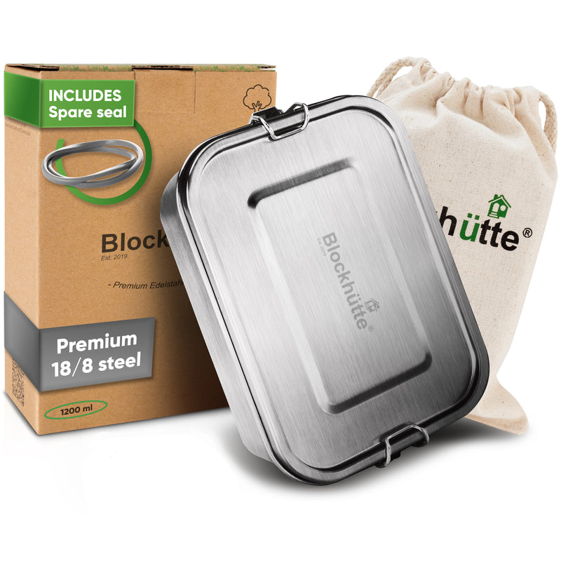 Stainless steel lunch box, 40 oz, closed, in front of its box labeled Includes spare seal and a cotton drawstring bag