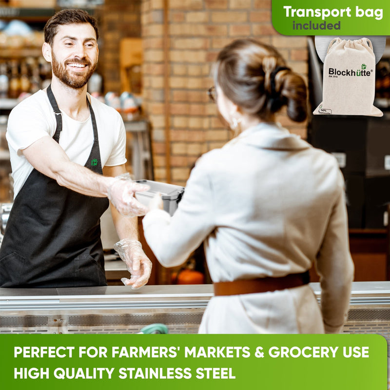 Deli clerk in a black apron handing a closed stainless steel lunch box to a customer across the counter; cotton bag inset